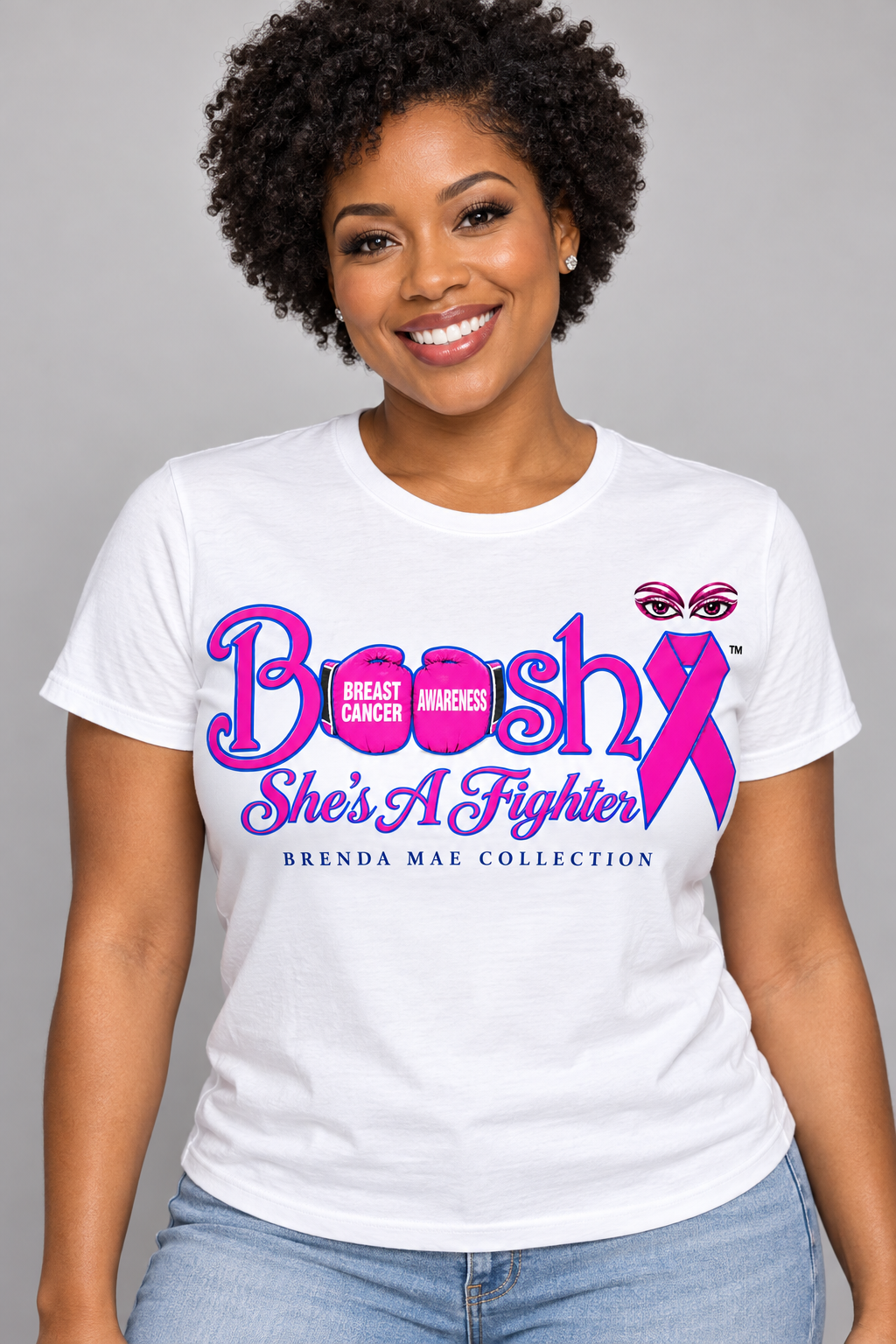 Design mockup of a white Brenda Mae Collection She's A Fighter breast cancer awareness tee